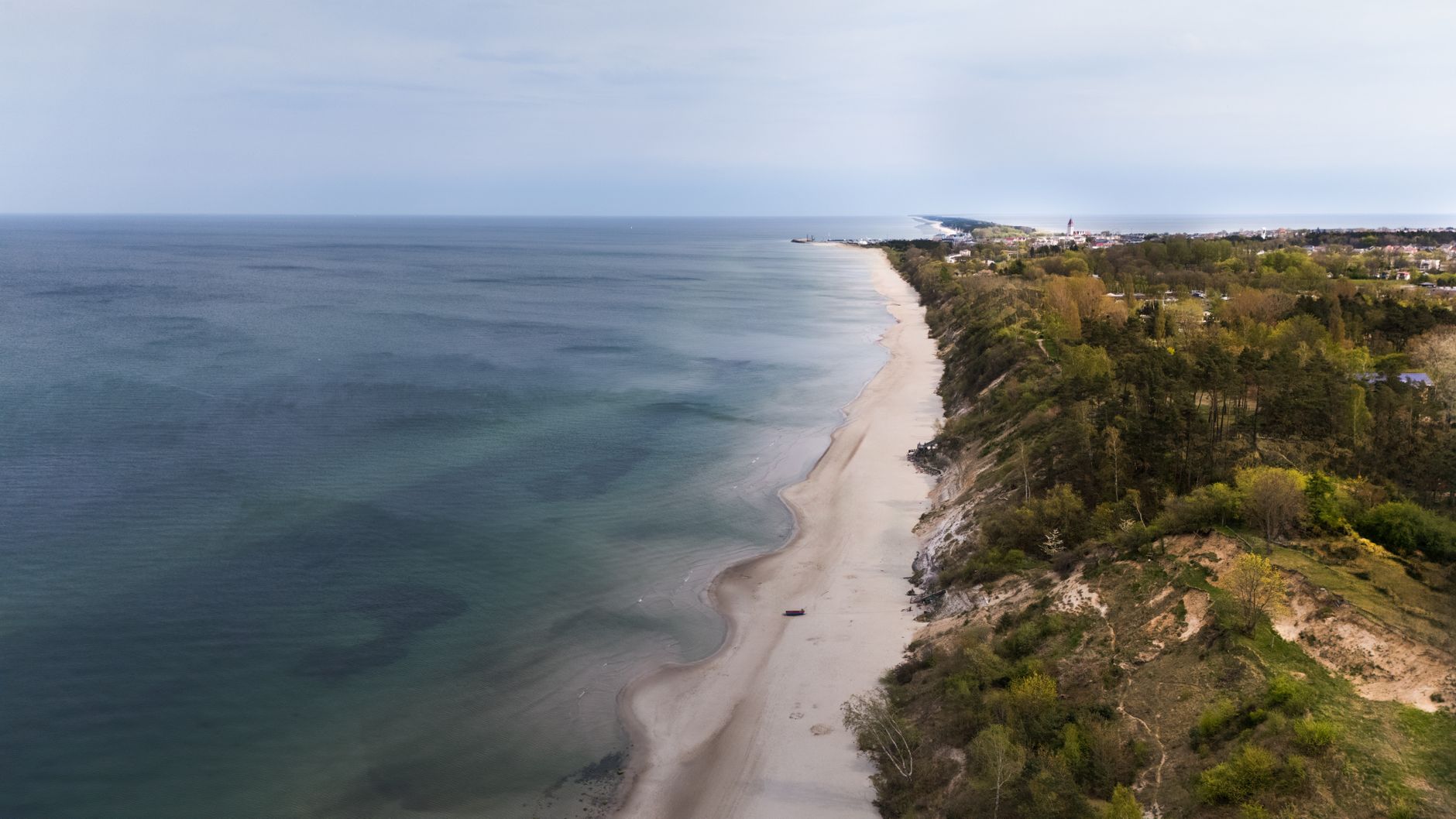 Scenic aerial view of Chłapowo, Poland coastline with sandy beaches and turquoise sea.