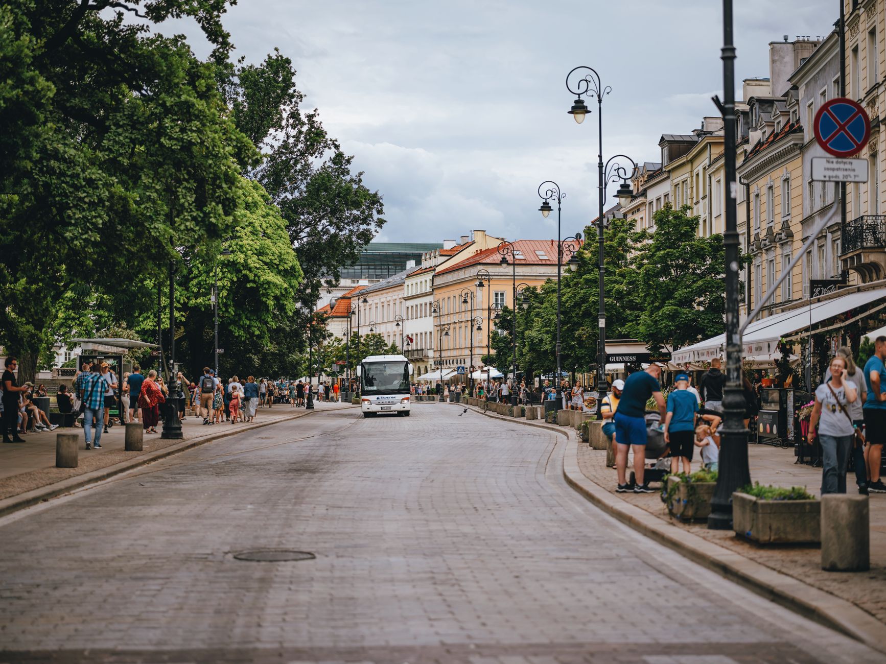 Dynamic city street scene in Warsaw, showcasing architecture and daily life.