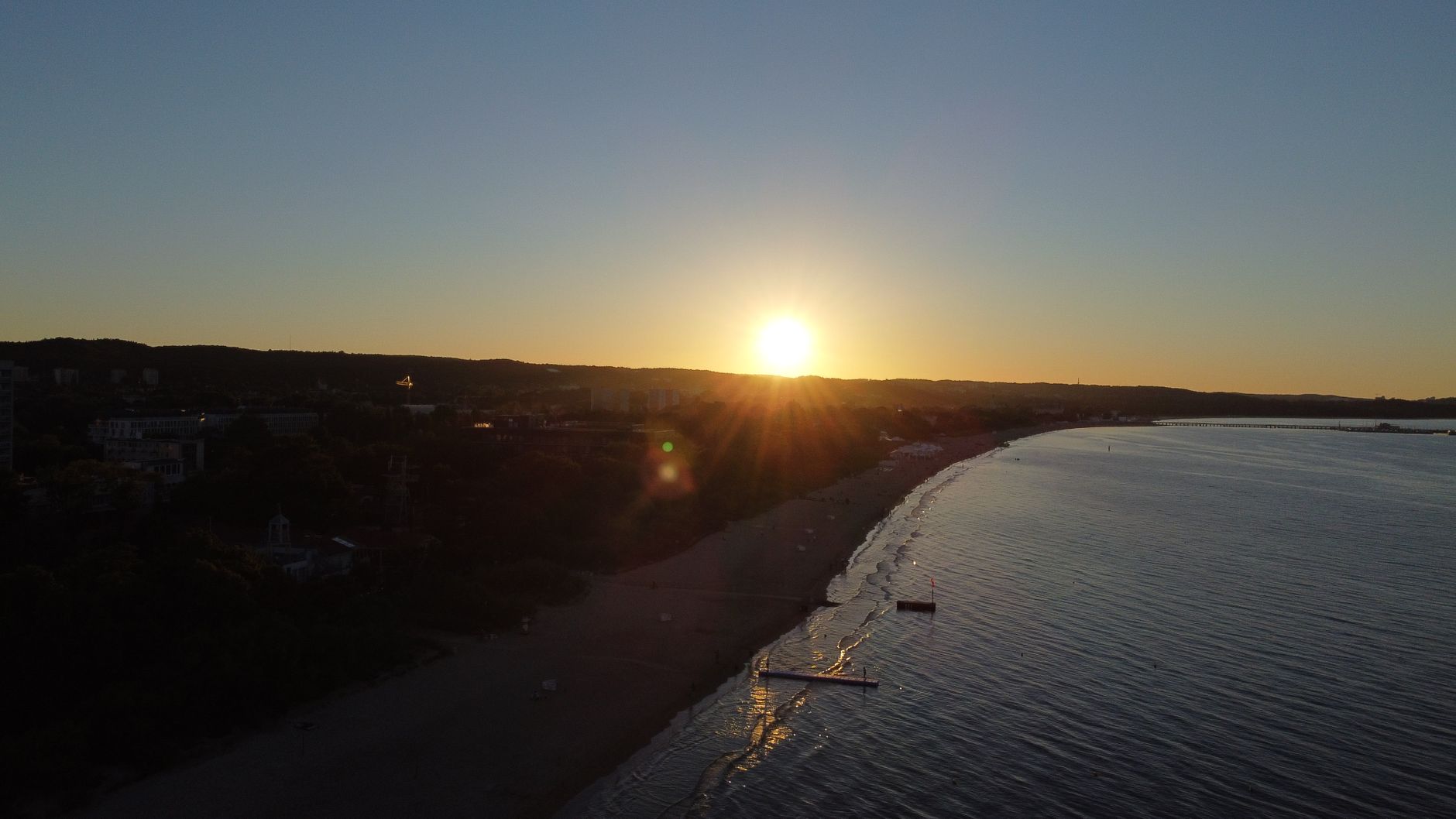 Drone shot capturing a stunning sunset over Sopot beach in Pomorskie, Poland.