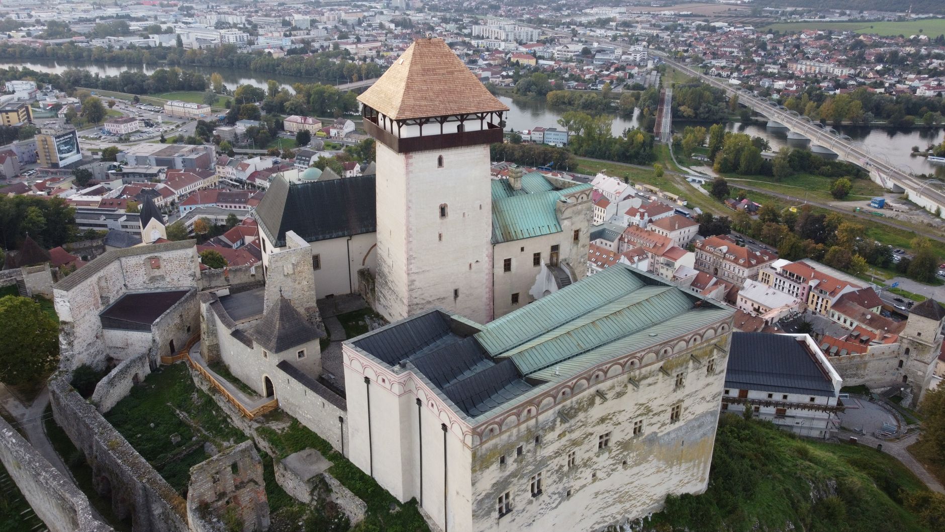 Discover the majestic Trenčín Castle overlooking the town in Slovakia with an aerial perspective.