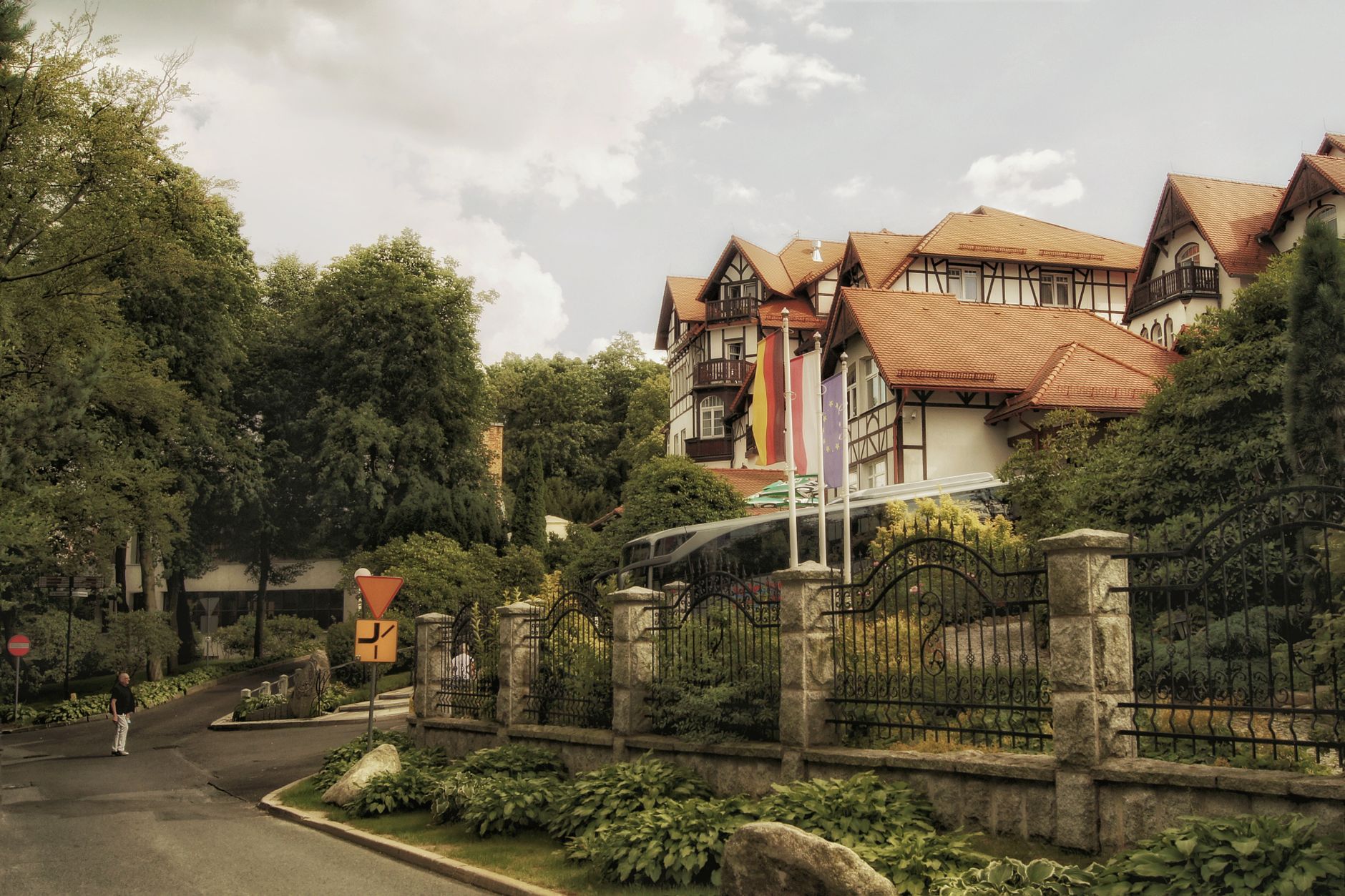 Picturesque view of historic buildings surrounded by lush greenery in Świeradów-Zdrój, Poland.