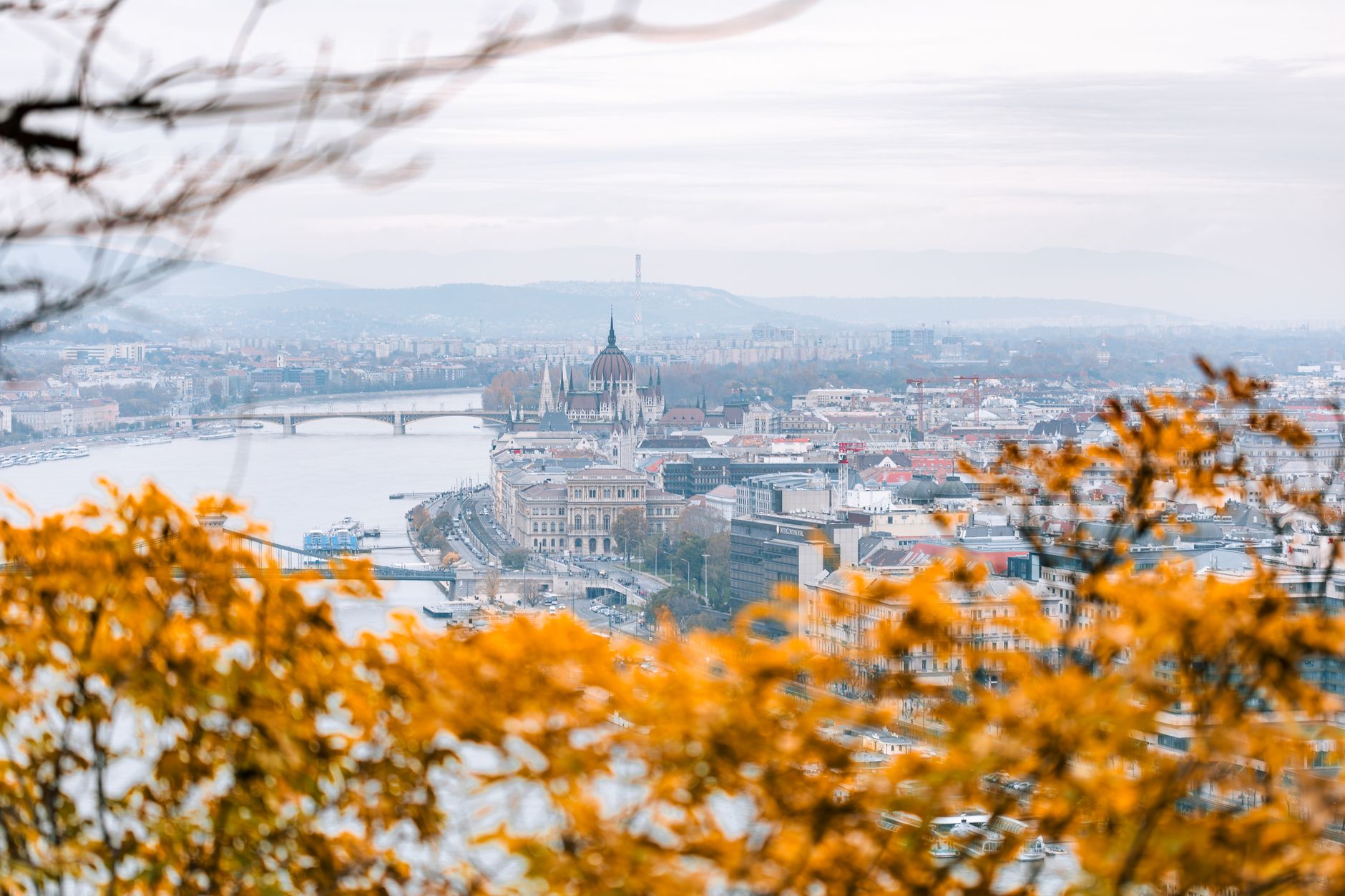 Gorgeous autumn landscape of Budapest featuring the Hungarian Parliament Building and the Danube River.
