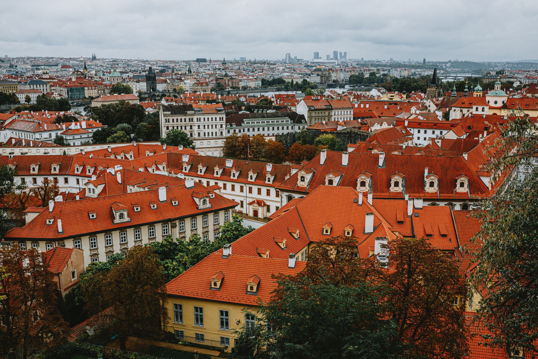 A picturesque aerial view of historic Prague showcasing its iconic red rooftops and intricate architecture.