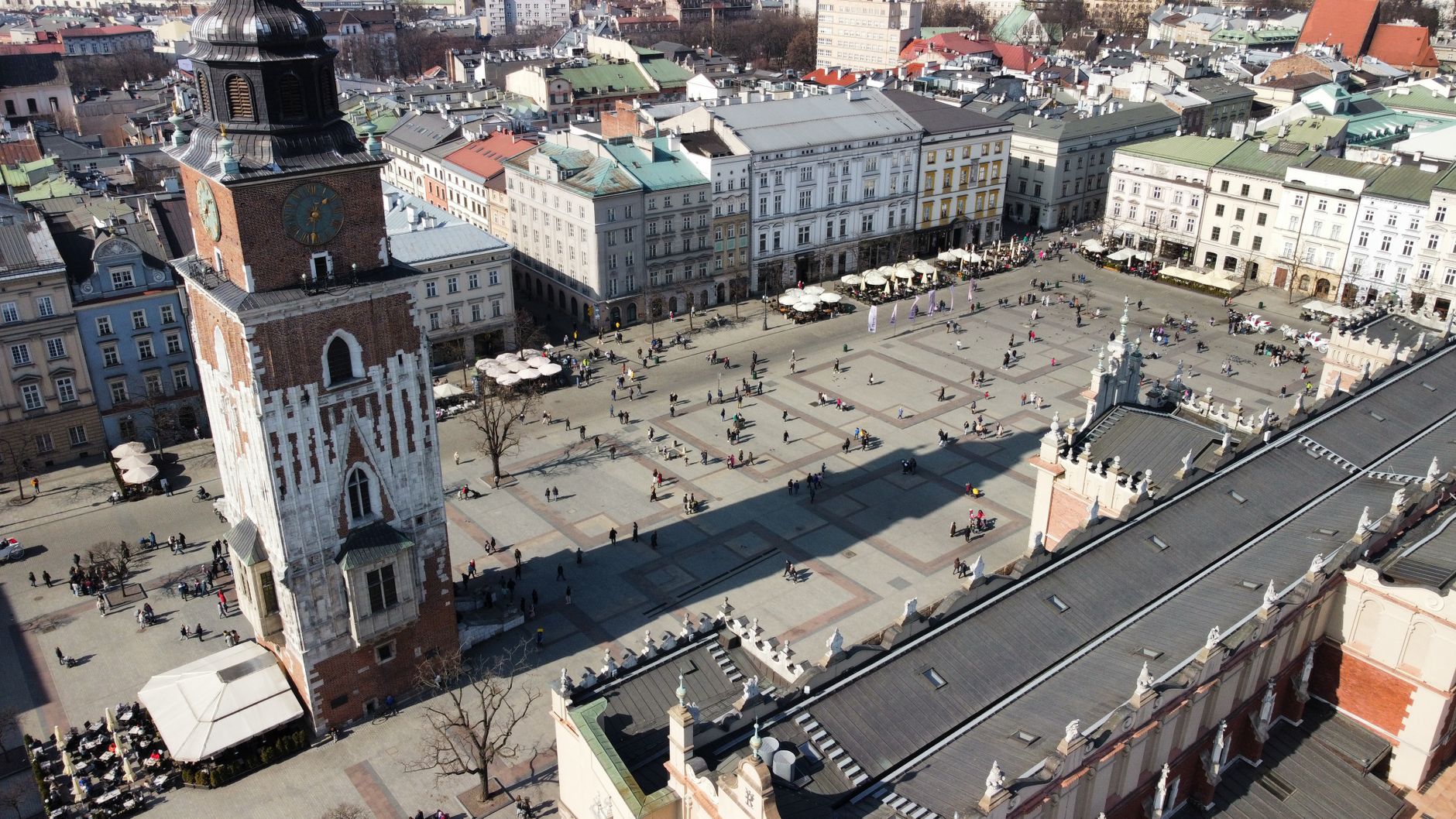 Aerial photo of Kraków's Market Square showcasing the famous Town Hall Tower and surrounding architecture.