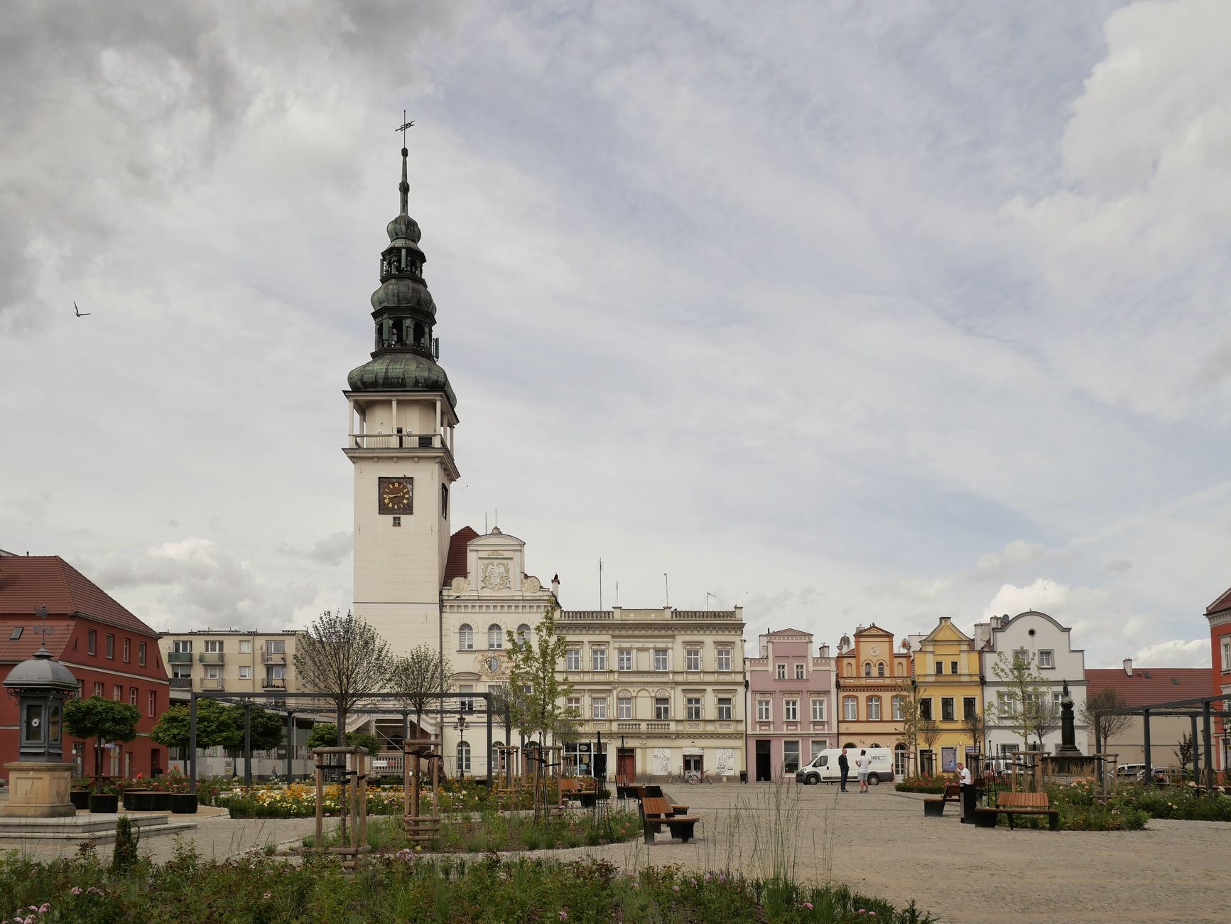 Charming view of a historic town square highlighting colorful architecture and iconic clock tower in Bytom Odrzański, Poland.