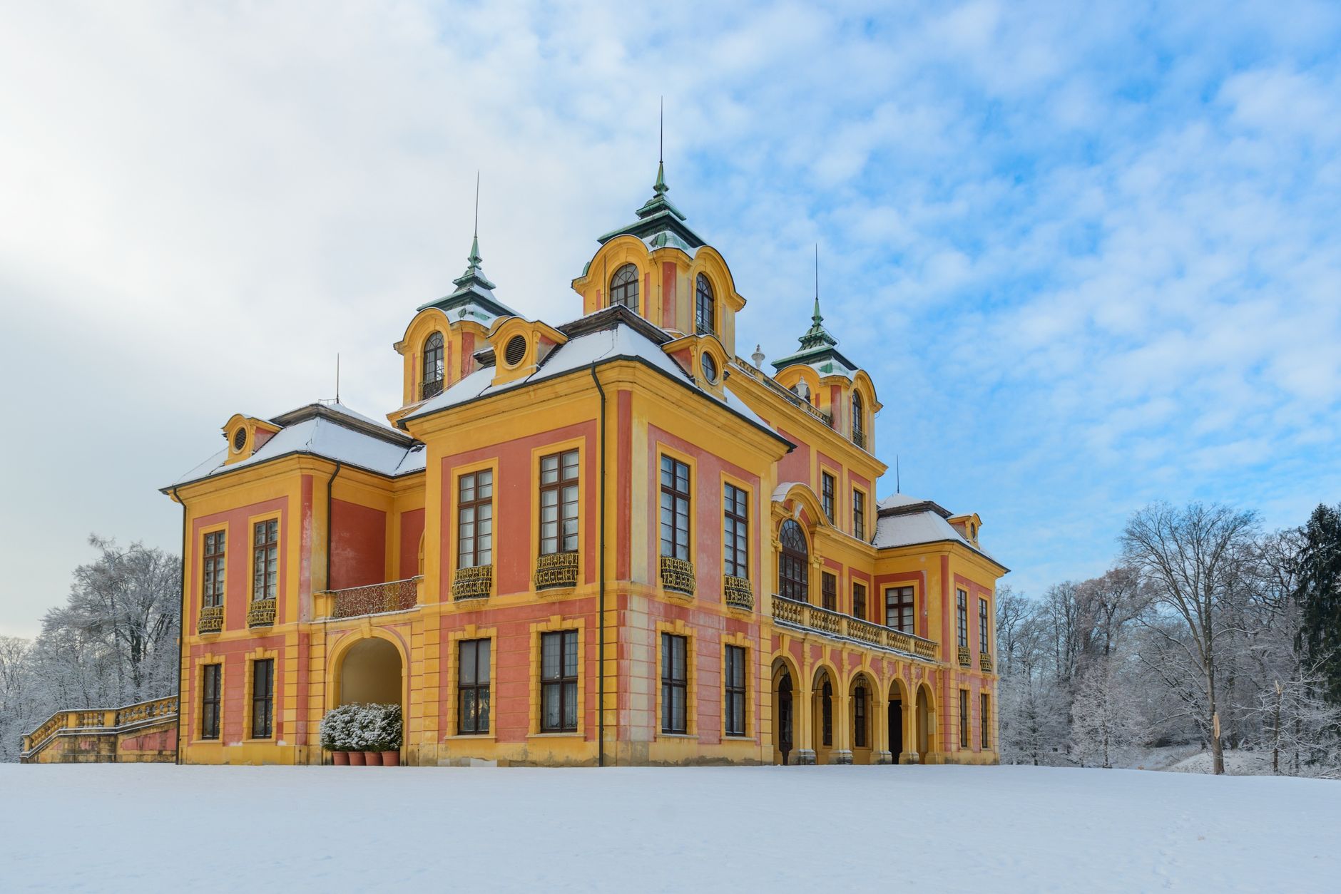 Historic Schloss Favorite hunting lodge in snowy landscape, perfect for travel and architecture enthusiasts.