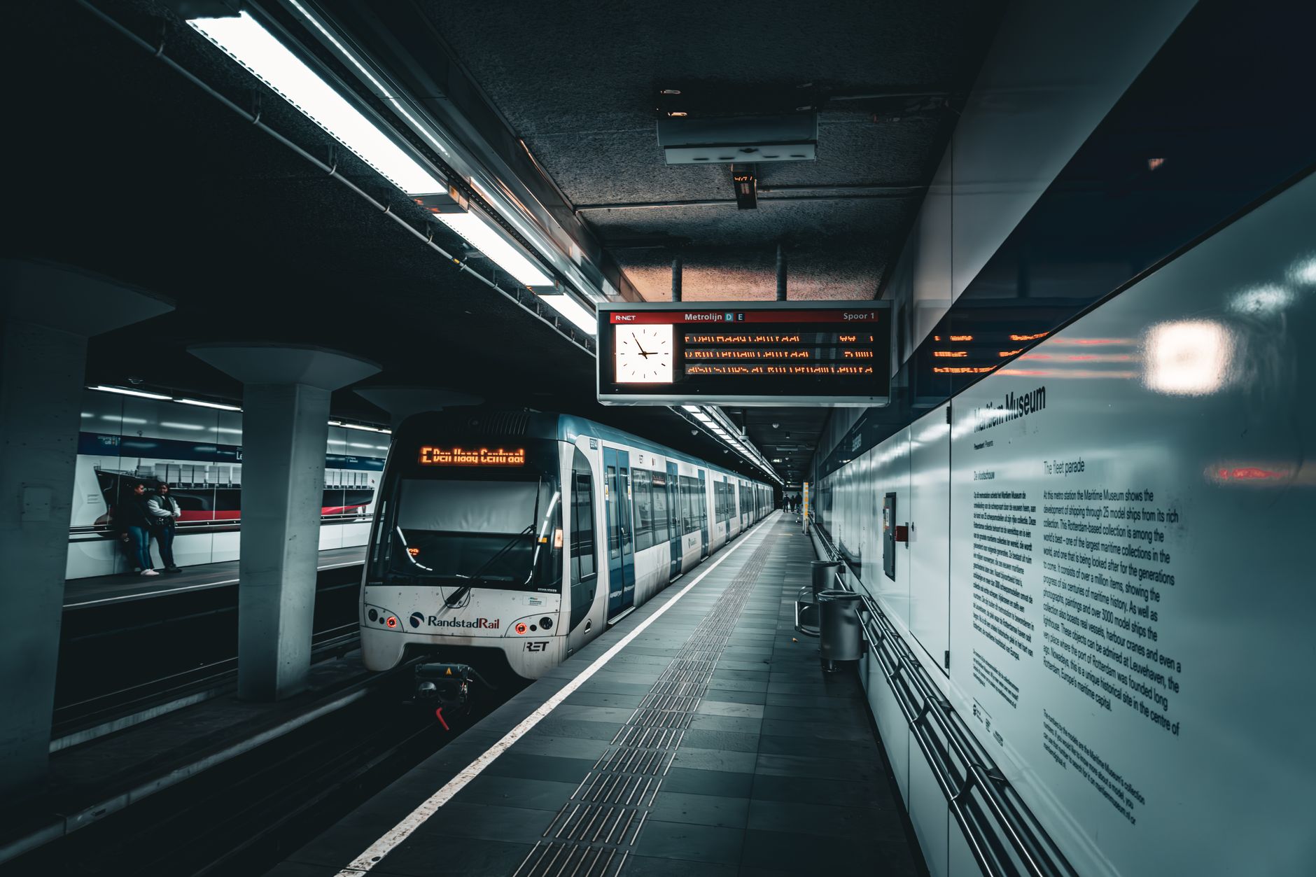 A sleek metro train in an illuminated underground station, showcasing modern rail transport.